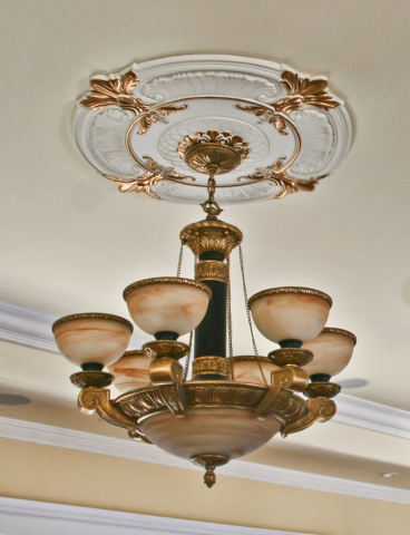 Ceiling medallion shown with ornate chandelier