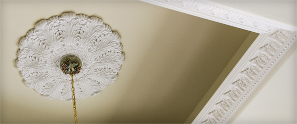 White ceiling medallion on recessed ceiling